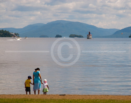 HD_P-37 - Mother with two young children walking on the beach near Lake George Village, New York. HD_P-37 - Mother with two young children walking on the beach near Lake George Village, New York.