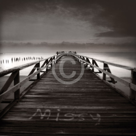 HD_STBW-26 - Early morning view of fishing pier on beach with stormy clouds in distance.