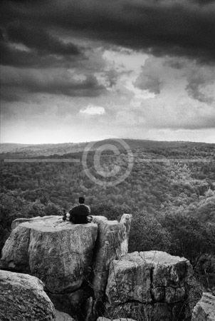 HD_STBW-44 - Lone hiker sits on one of the boulders at Chimney Rock located in Catoctin Mountain Park in Maryland